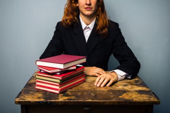 Businesswoman with stack of books